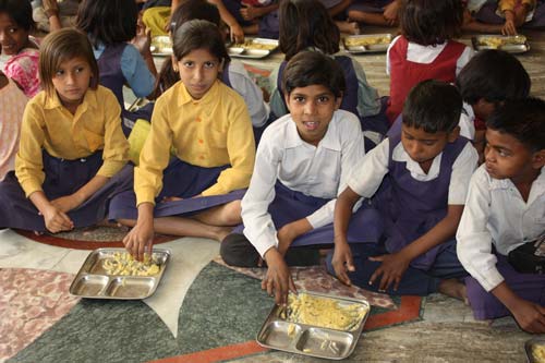 Siblings eating from one Plate at the Ashram