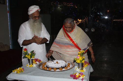Ammaji cutting the cake on her birthday