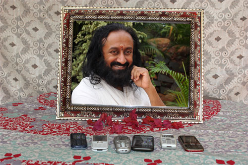 Throw away your mobile phone charger - use a photo of Sri Sri Ravi Shankar instead