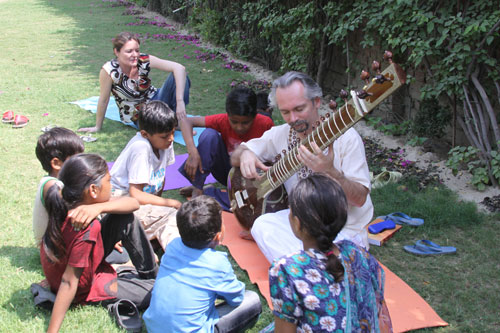 Thomas showing the children his Sitar