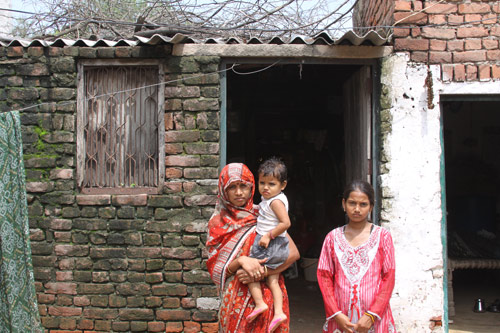 Nandini with her Stepmother and Stepsister in front of their home