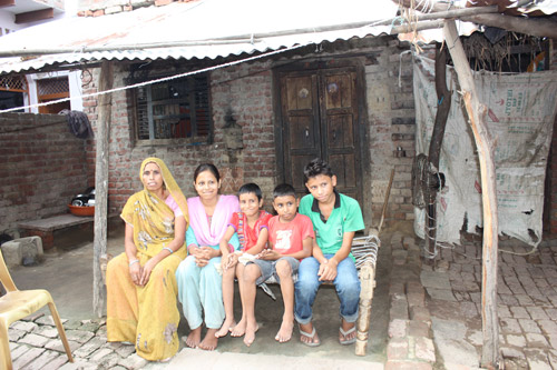 Neha, Shivam and their Family in front of their Home
