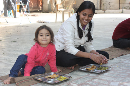 Apra eating with the Schoolchildren