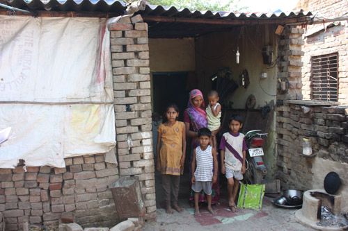 Lokesh and Kaushal in front of their home